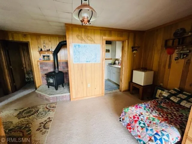 View of living room from family room, looking into kitchen to the right and bedroom to left