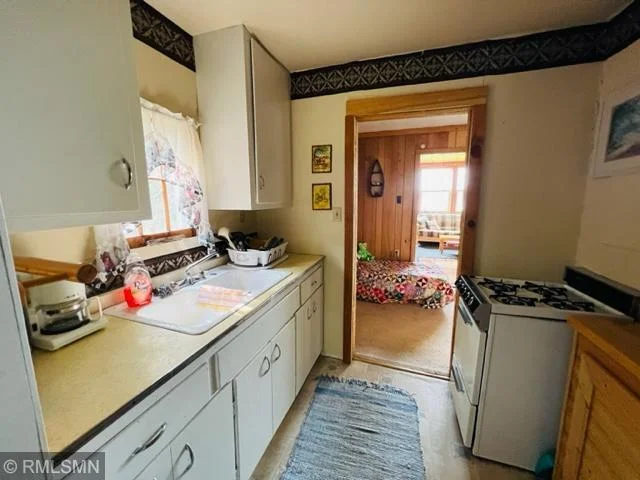 Kitchen from bathroom looking into living room