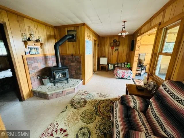 Another view of living room and peeking into bedroom 2 on left, family room on right