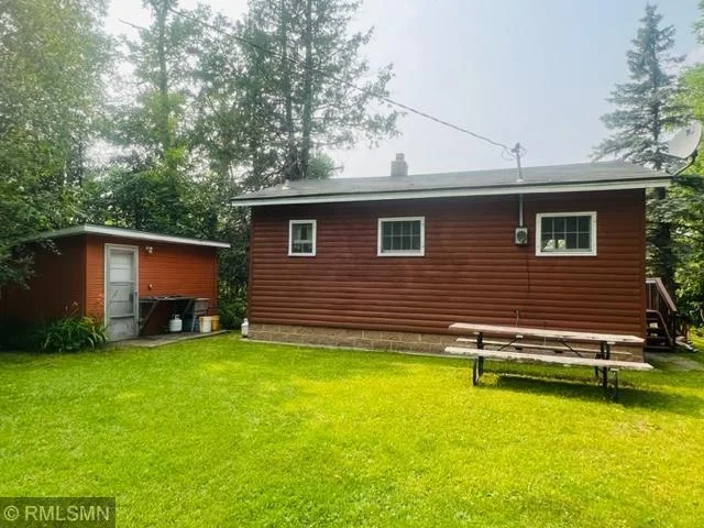 Back of cabin and one shed