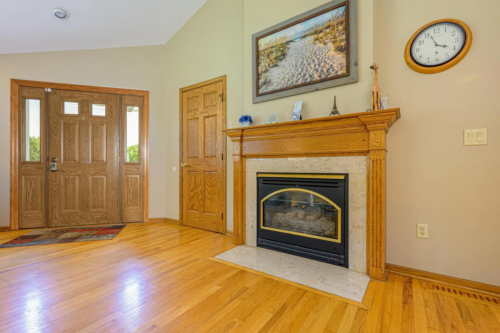 The gas fireplace features a granite and wood surround.