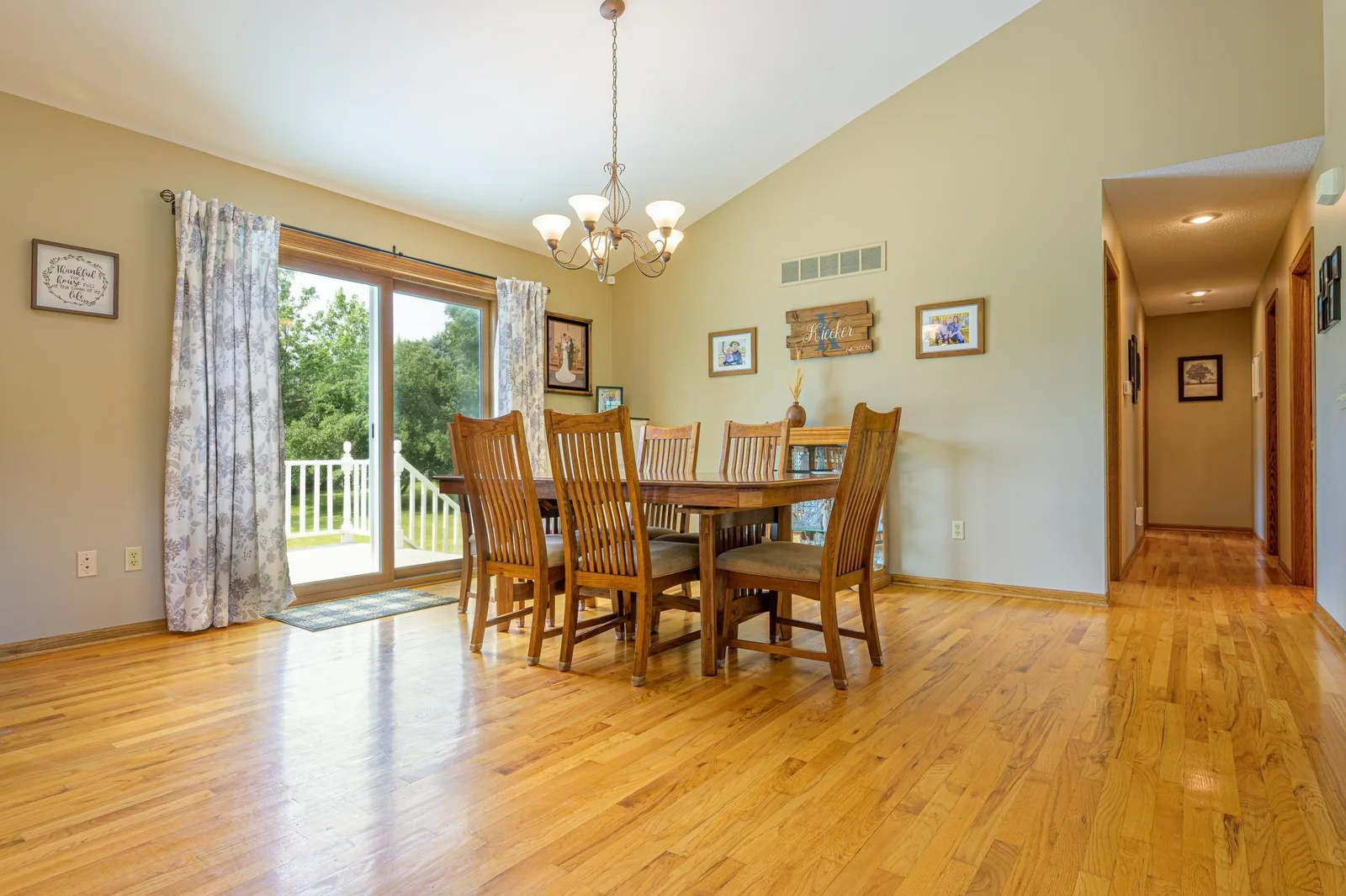 The dining room features hardwood floors and a patio door that leads out to the deck.