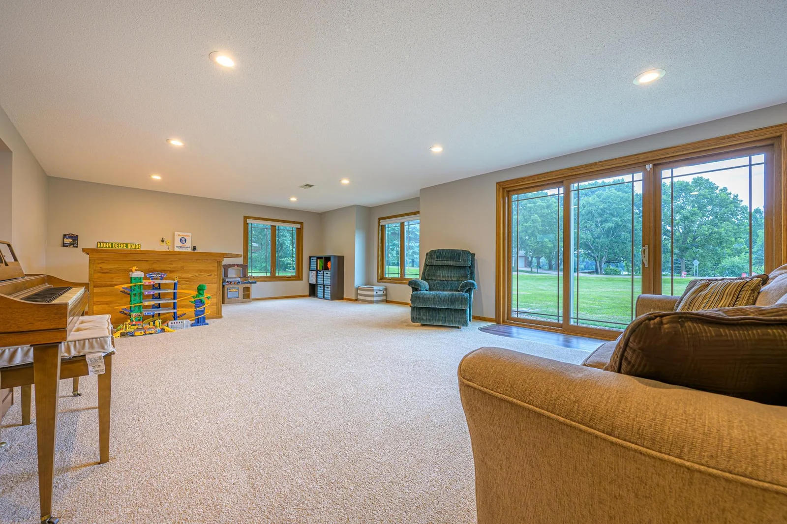 The spacious family room features a bar area and a patio door that leads outside.