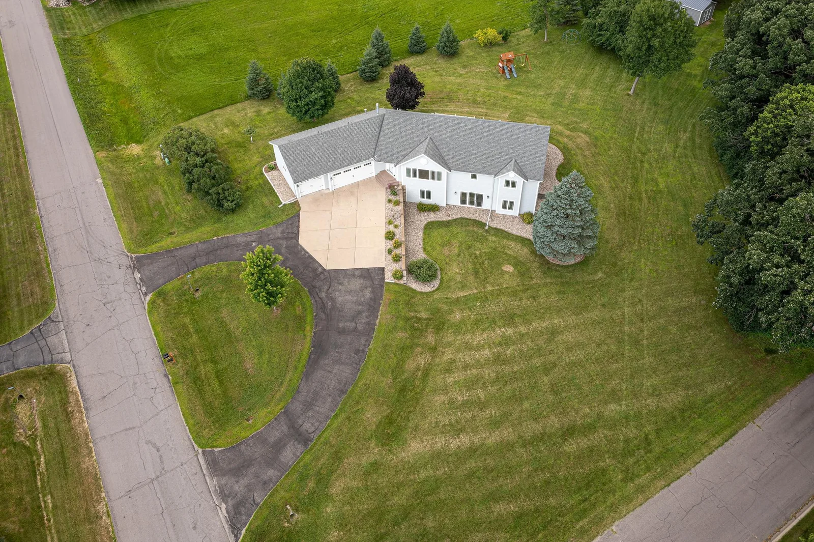 Home features a paved horseshoe driveway.