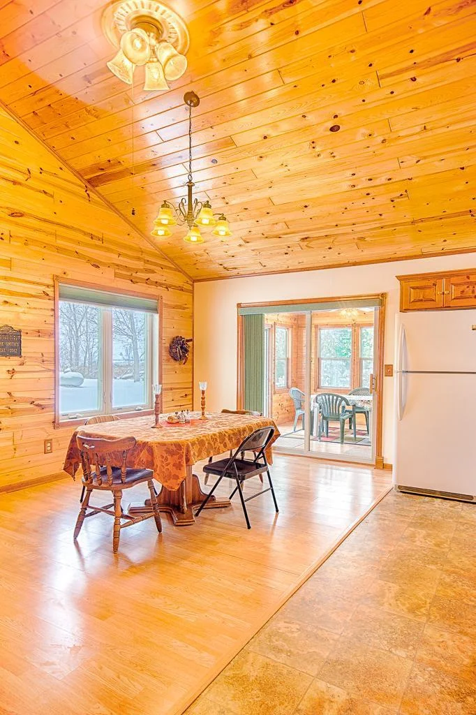 Dining room view highlight the patio door exit to 3-season porch.