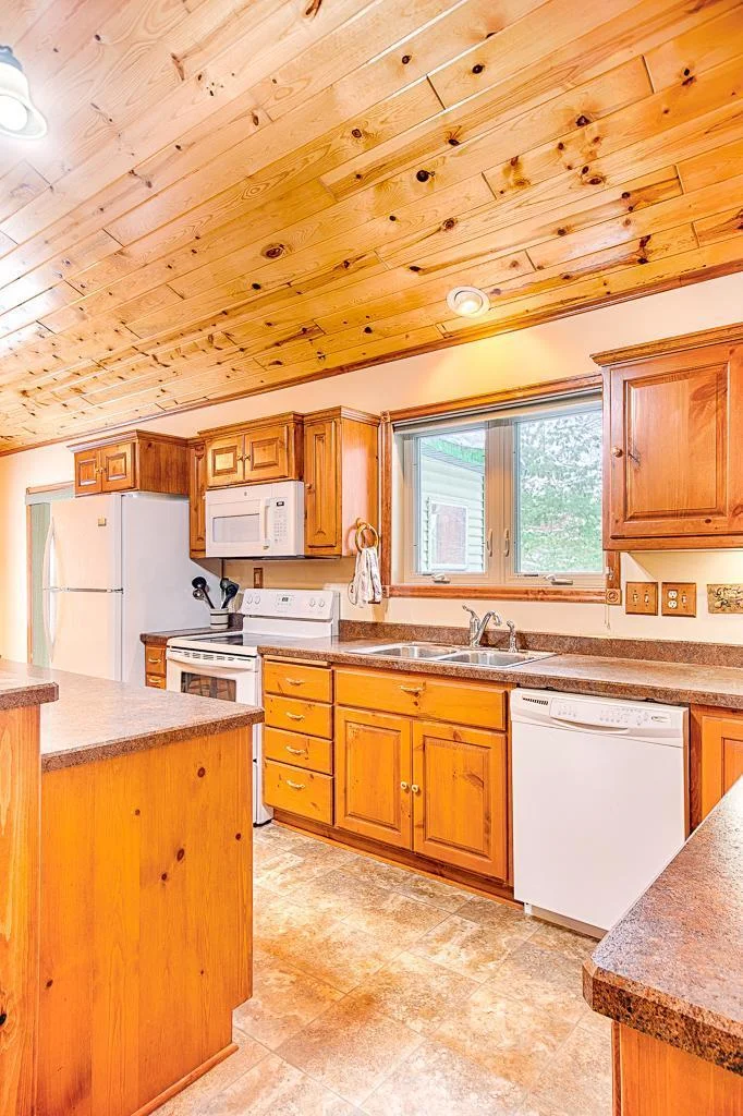 Kitchen view featuring the bright and airy and open feel, the lovely cabinetry, and breakfast island...