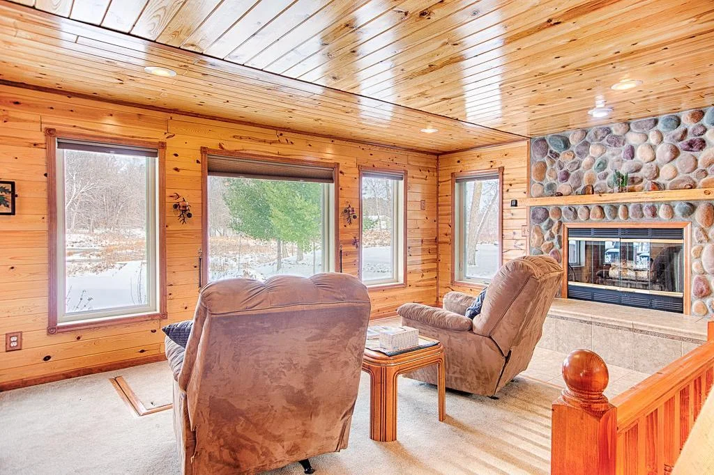 Just one step up from the first living room space, this is the 2nd tier cozy living room space with wood burning fireplace all setup to watch nature and great views overlooking Borden Creek!