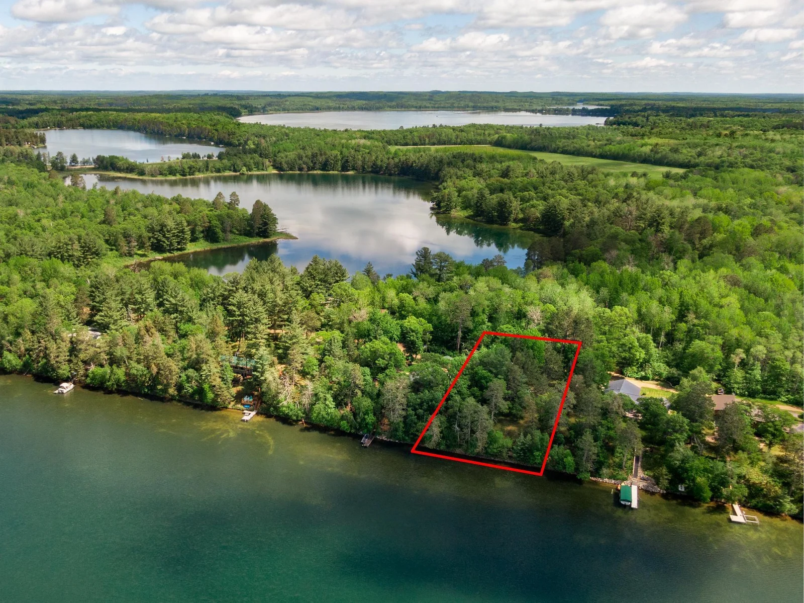 A perfect little lot for a new cabin or camper along the turquoise shores of Sanborn Lake.