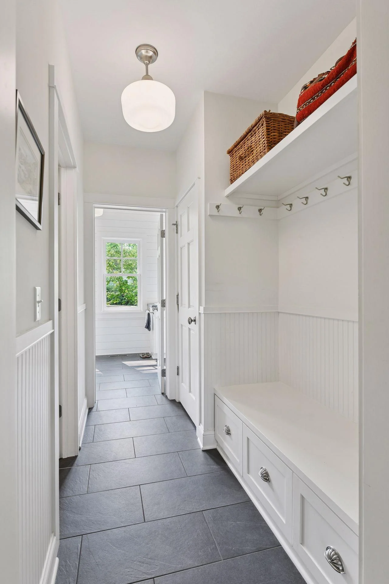 Mudroom with tile floor and custom storage bench
