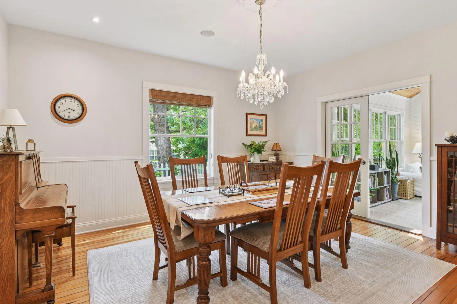 Formal dining room with french doors opening to the four seasons porch