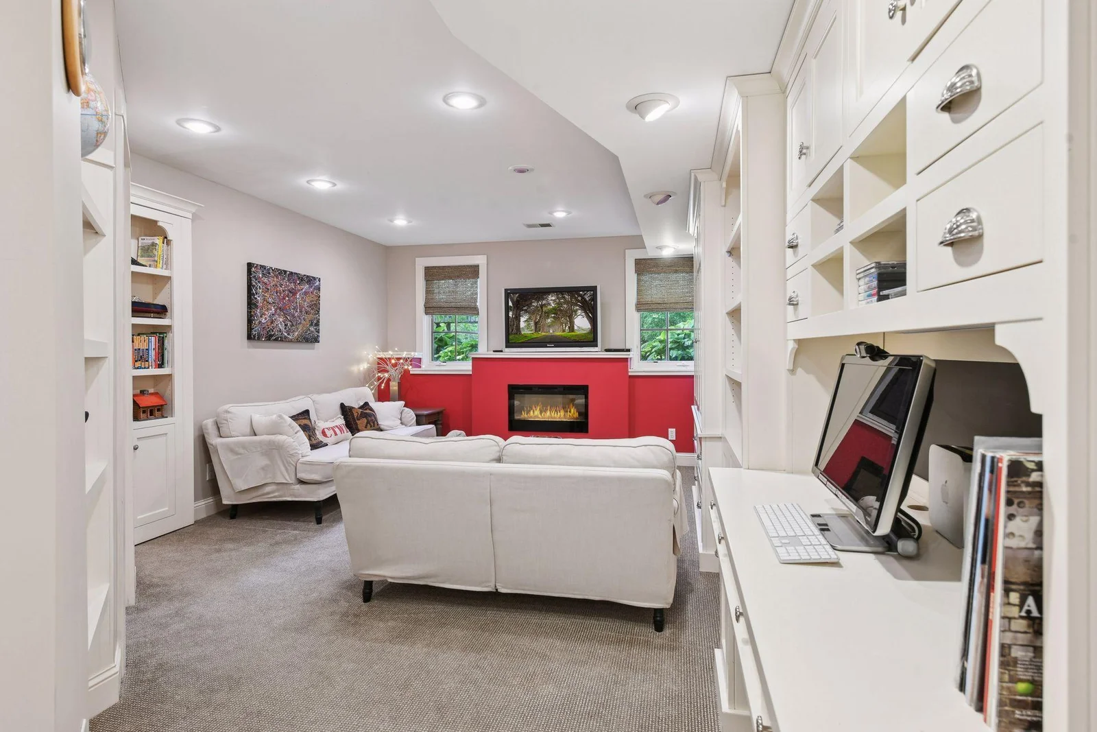 Lower level family room with fireplace and beautiful built in shelves