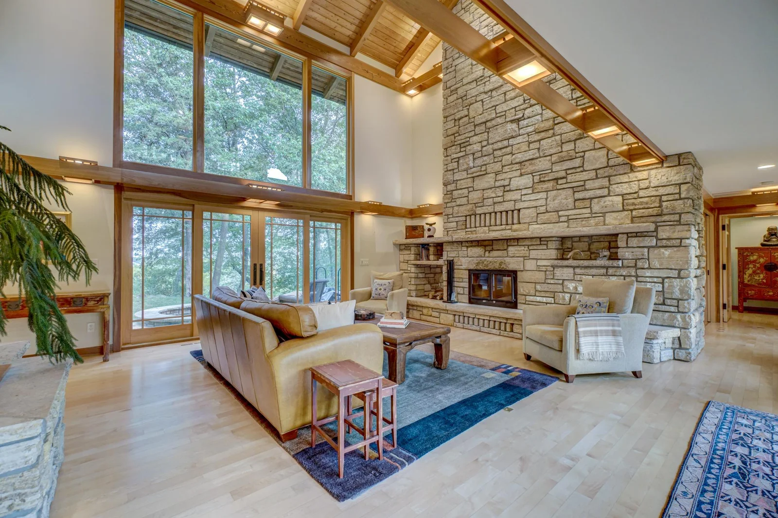 Impressive stone wood burning fireplace with vaulted ceilings in the living room