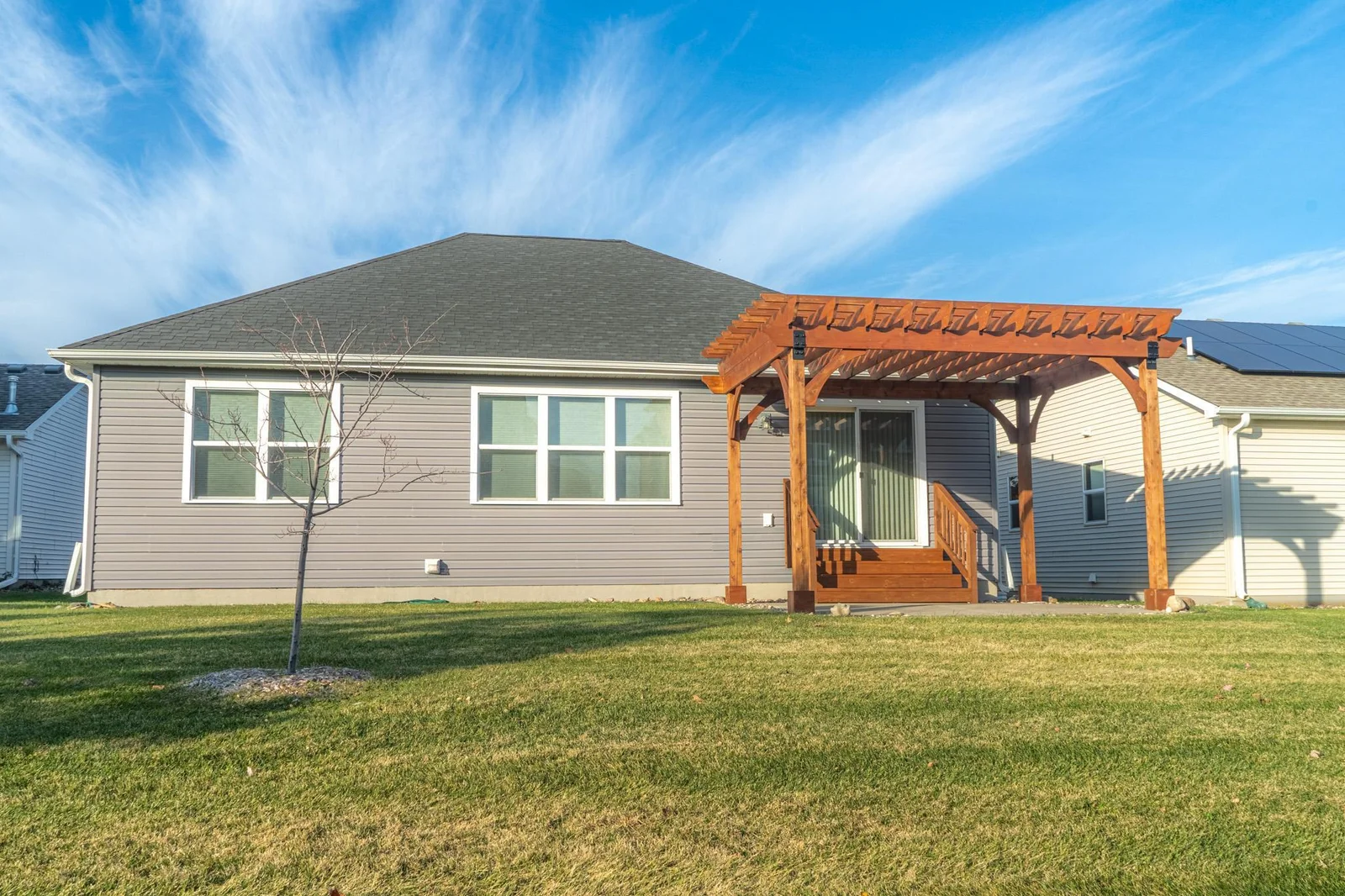 Backyard featuring a private wooden pergola, perfect for outdoor relaxation and entertaining.