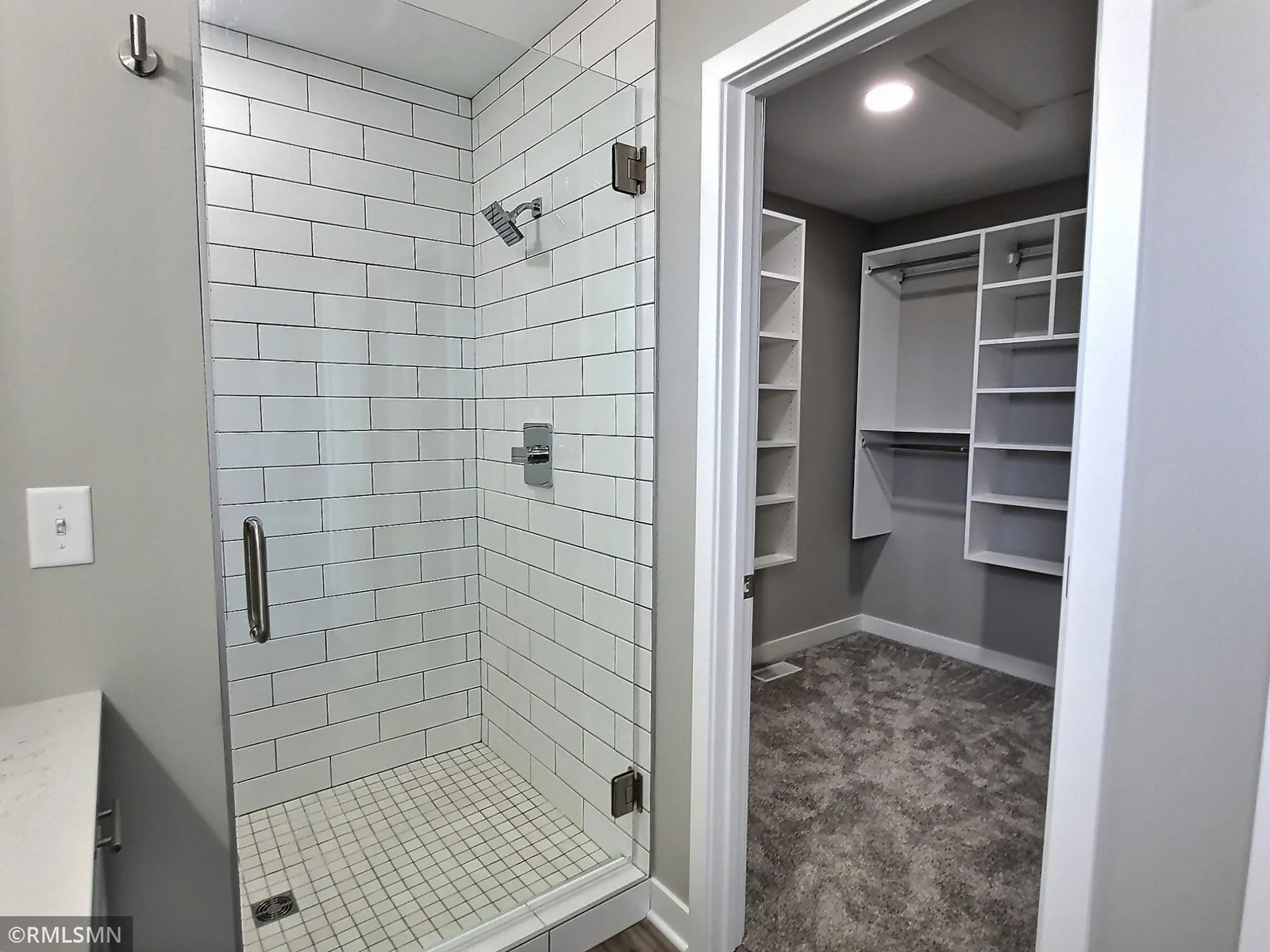 Close up of the walk in shower and walk in closet with customized closet shelving. Photo is from builders model home and this is what will be built on the lot.