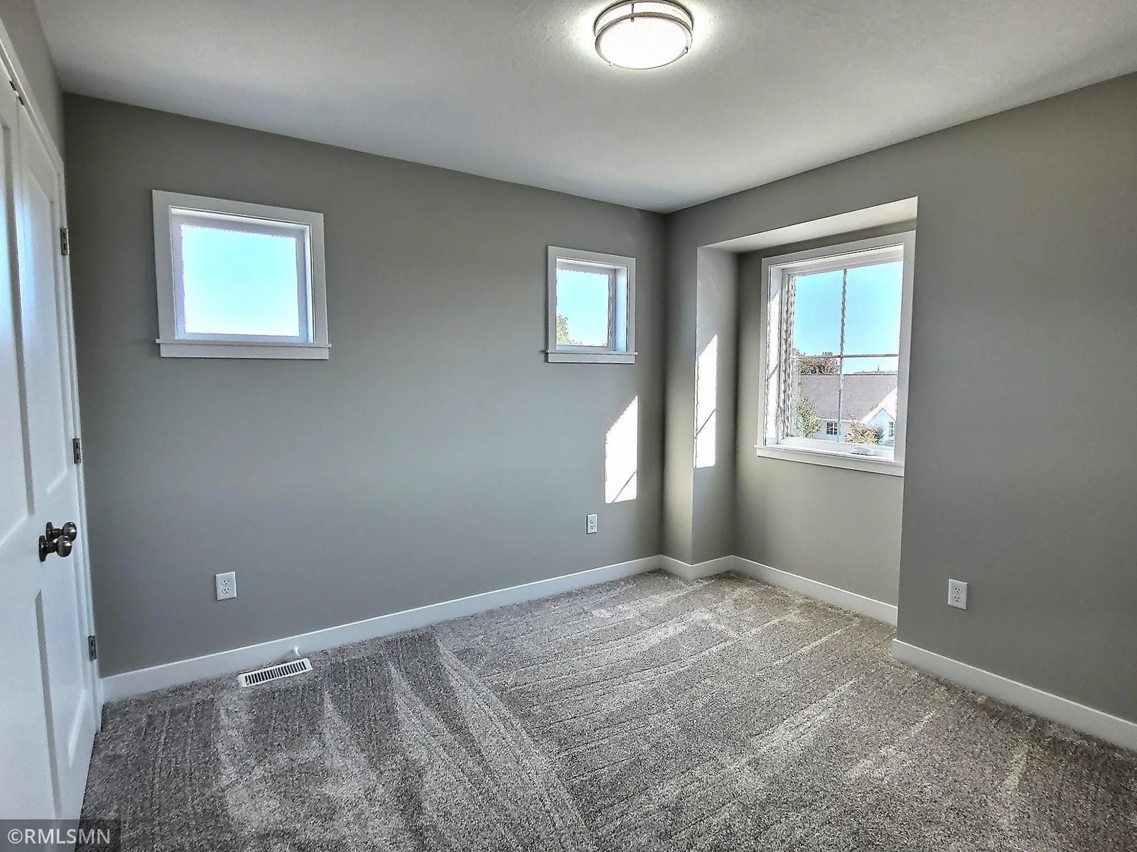 The upper level includes 3 bedrooms, 2 baths and the laundry room. Here is one of the bedrooms. Photo is from builders model home and this is what will be built on the lot.