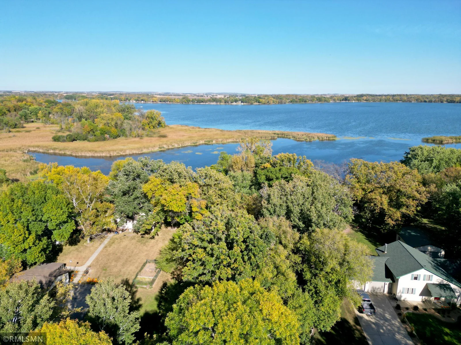 View of the lot from the road to the lake. As you seen nice wooded lot that will change when the new home is built but several trees will remain to keep the privacy.