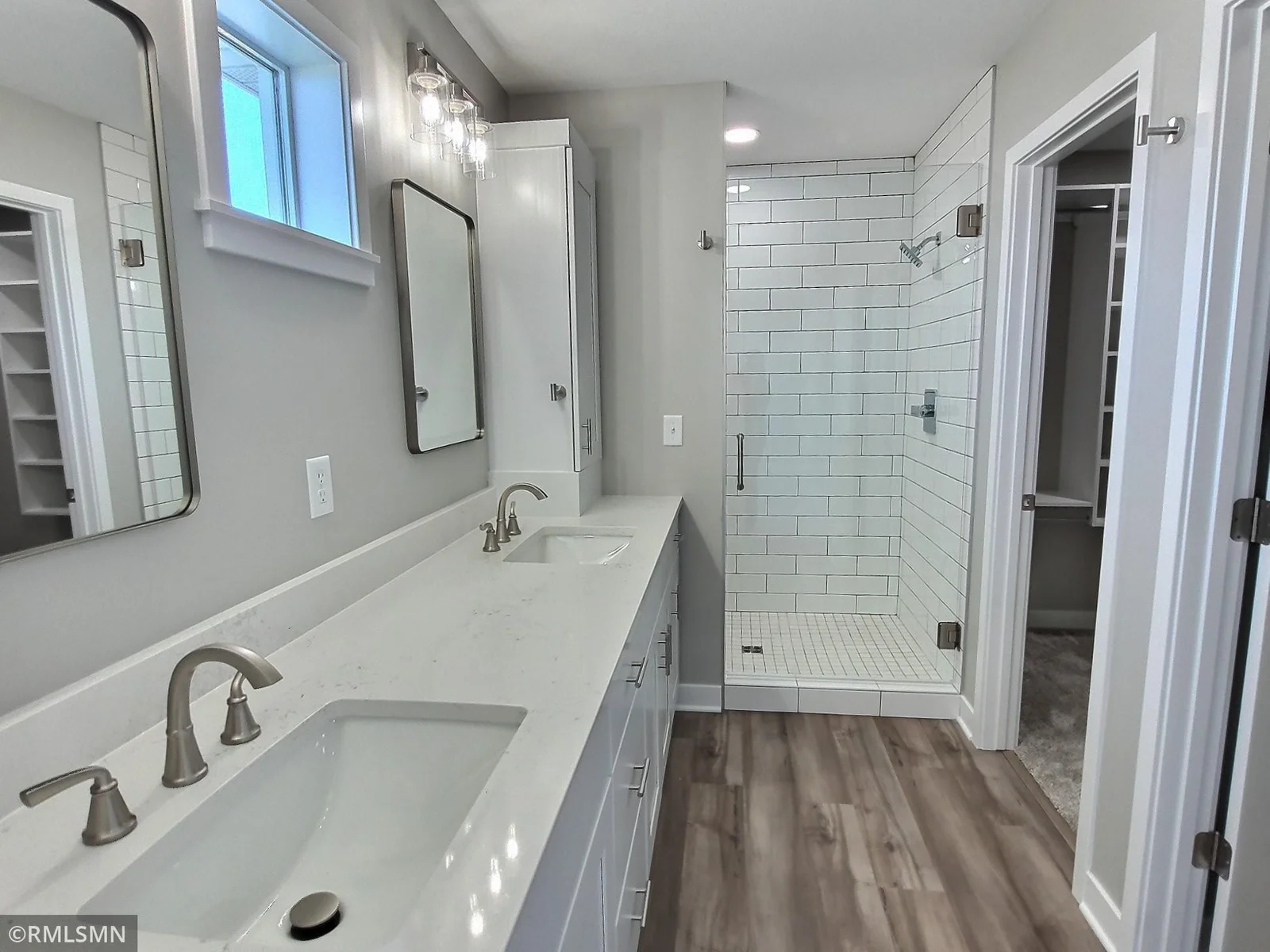 The bath is owners suite offers a beautiful time shower, dual sinks and private toilet room. Photo is from builders model home and this is what will be built on the lot.