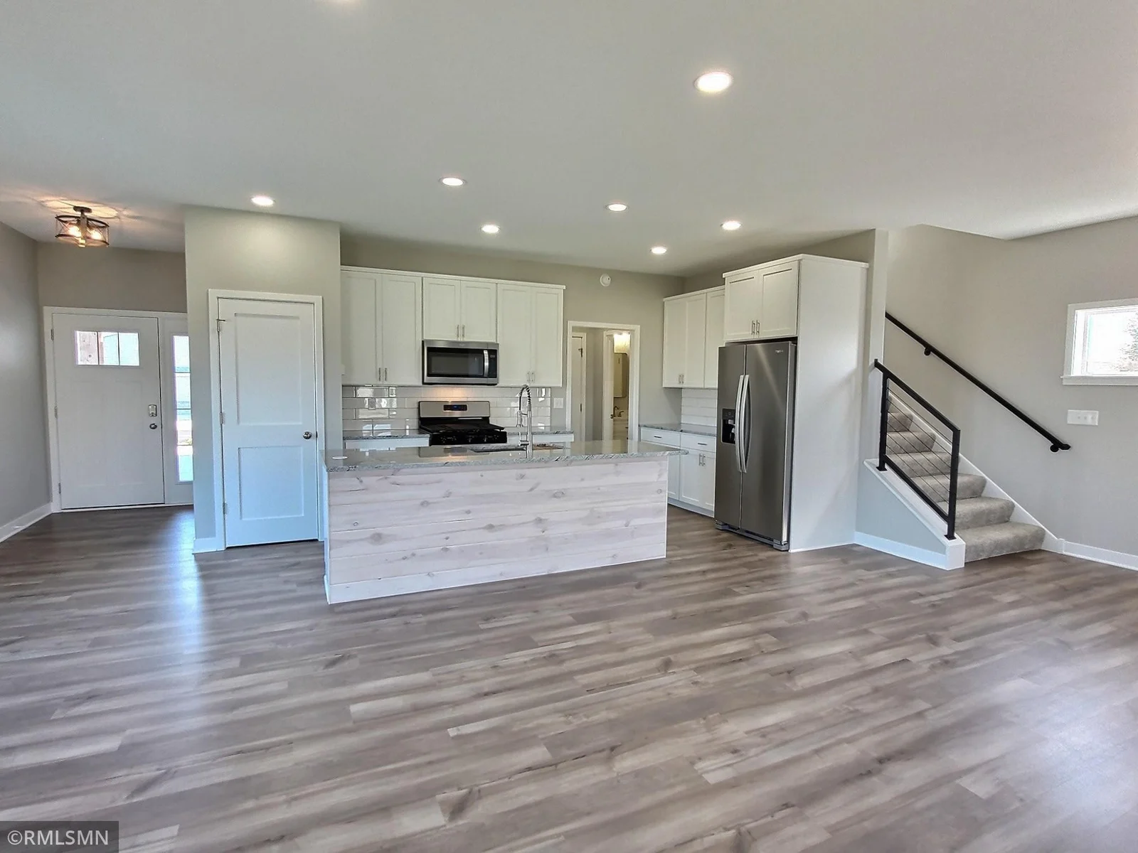 The main level of the home has an open design and layout ideal for entertaining at the lake. LVP flooring runs throughout for quick easy cleaning. Imagine everyone just coming in from the lake and now meeting in this area for a meal.