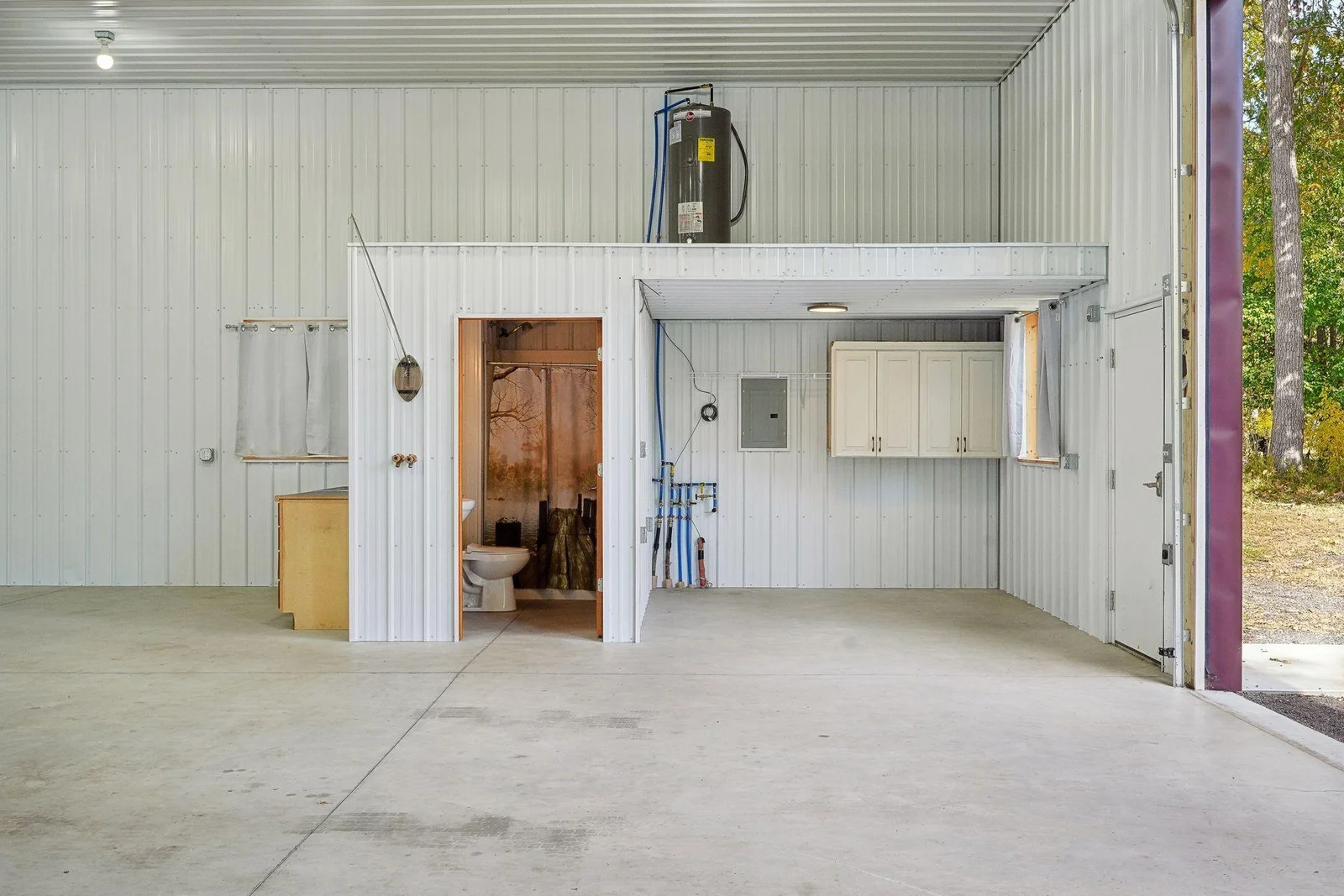 shop view of 3/4 bath, storage and mezzanine area.