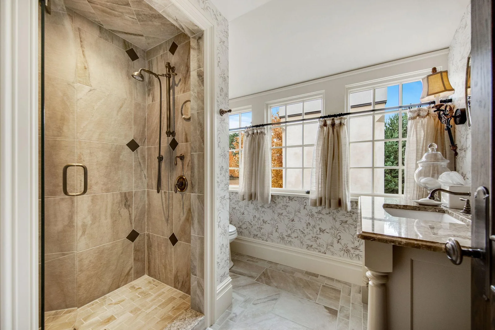 Connected to the sitting room is a private bathroom, complete with luxurious finishes. A spacious shower, elegant fixtures, and tasteful decor.