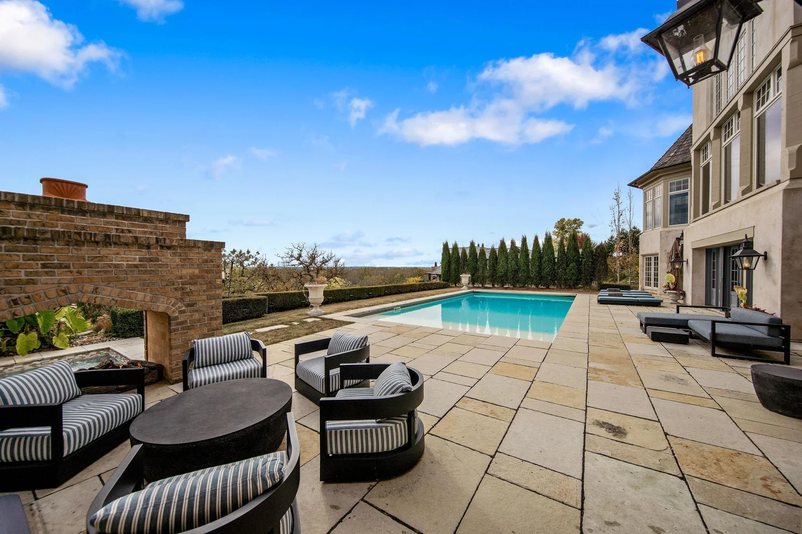A cozy fire pit area is surrounded by comfortable seating.