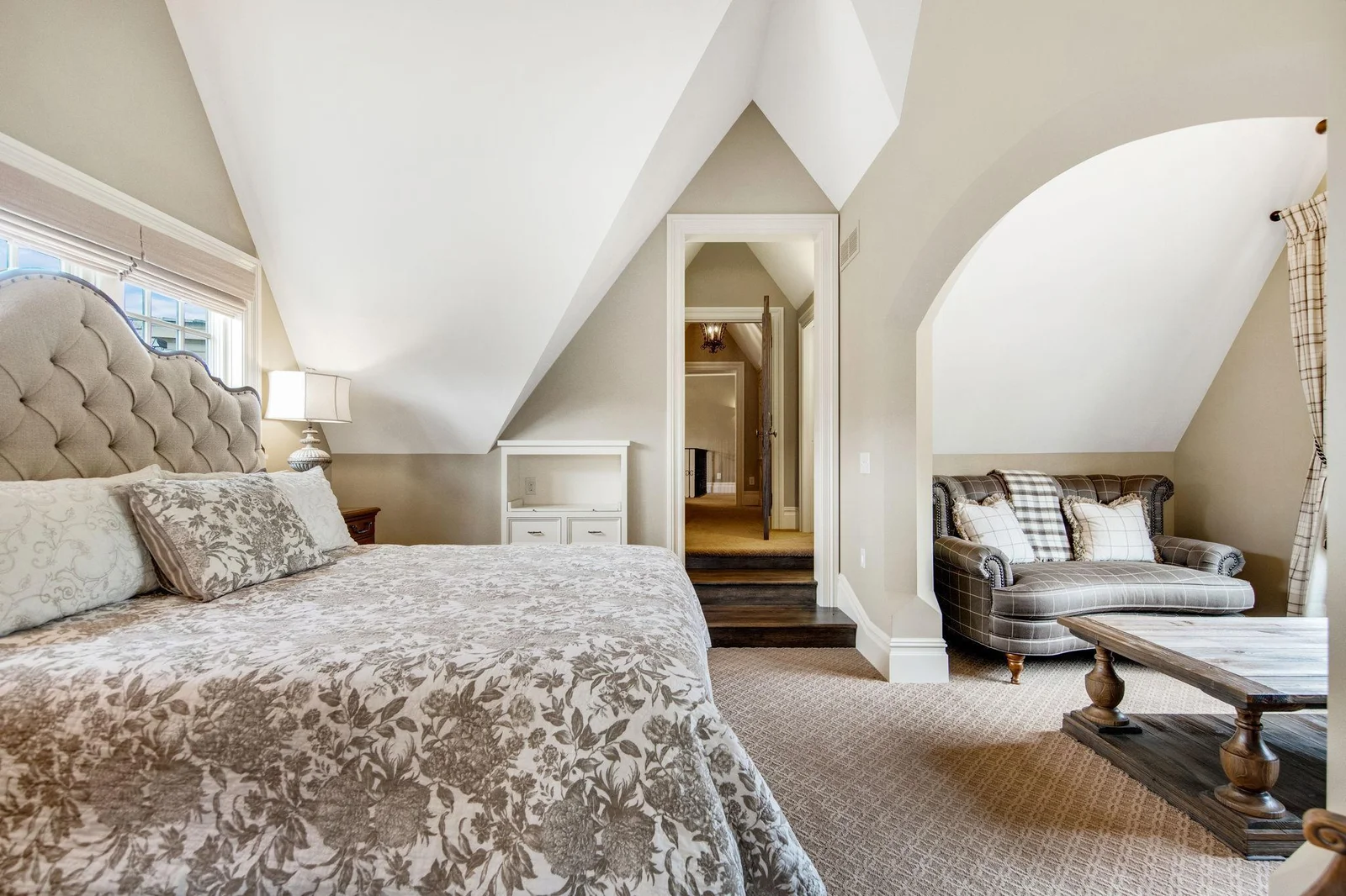 This bedroom retreat features a cozy sitting room, perfect for relaxation and conversation. This space is thoughtfully designed to offer comfort and privacy.