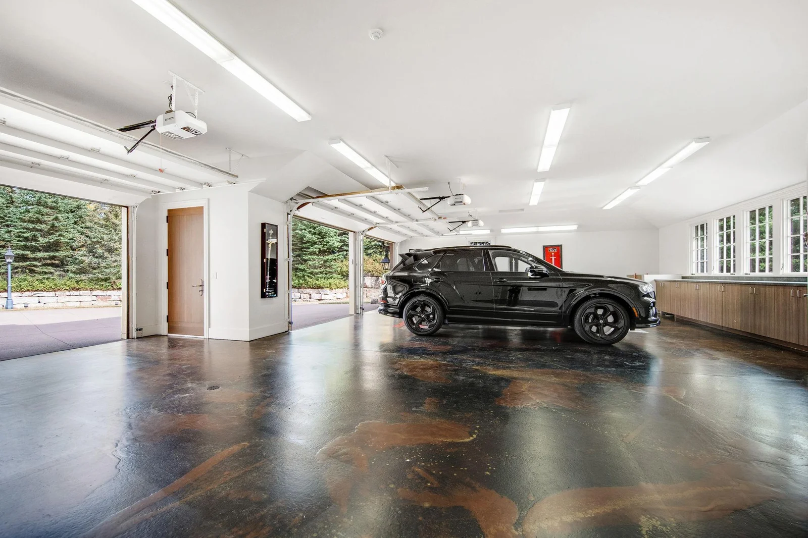 The massive attached three-car garage is a true dream for any car enthusiast or family in need of extra space. With ample room for vehicles, it also boasts tons of storage options.