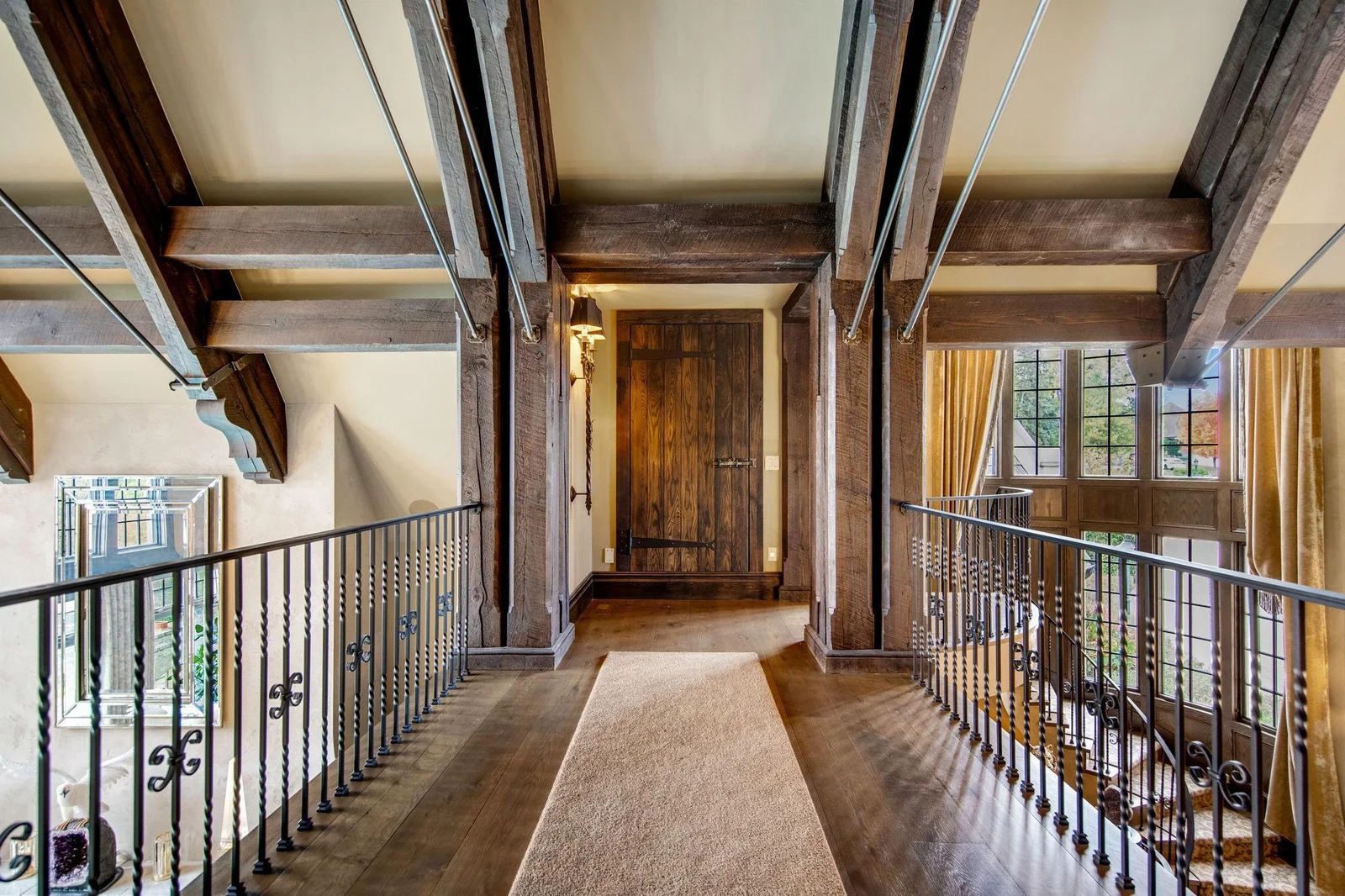 The catwalk serves as a stylish transition, connecting the upper level to the main living areas while maintaining an open, flowing layout. This unique feature not only adds architectural interest but also allows for a seamless journey back downstairs