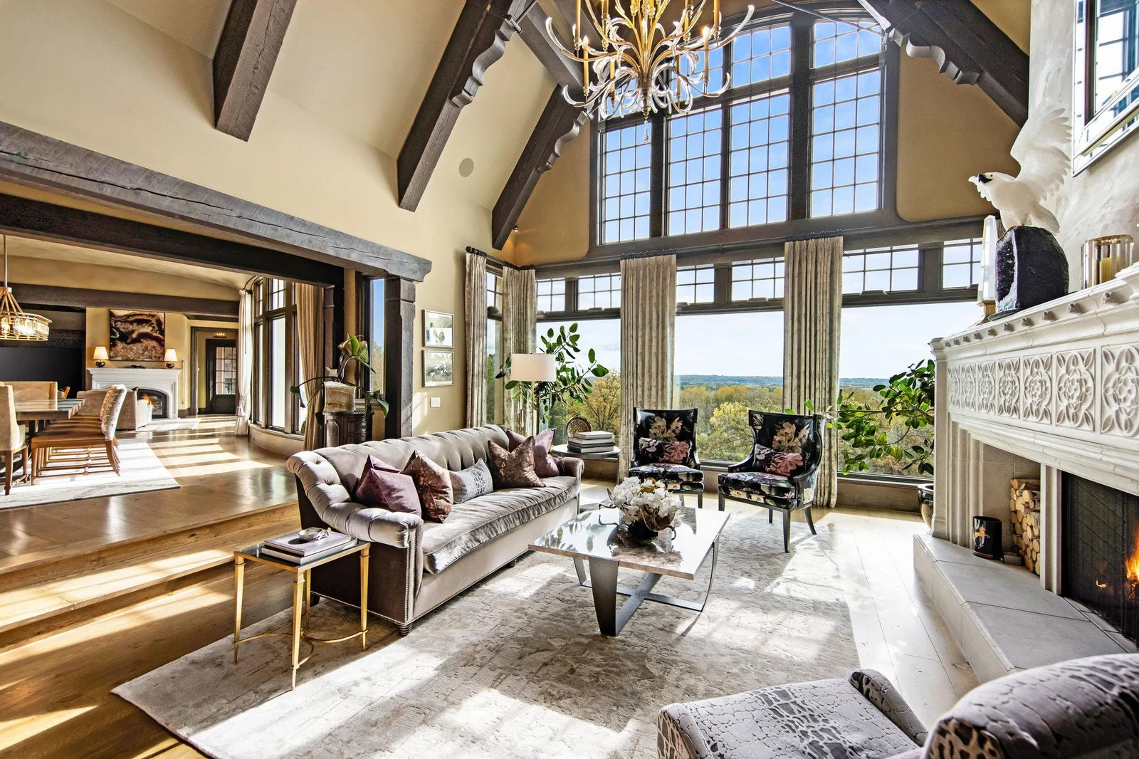 Expansive windows frame breathtaking views of the surrounding landscape, inviting natural light to flood the space. The scenery feels like a living painting, seamlessly blending the beauty of the outdoors with the charm of the interior.