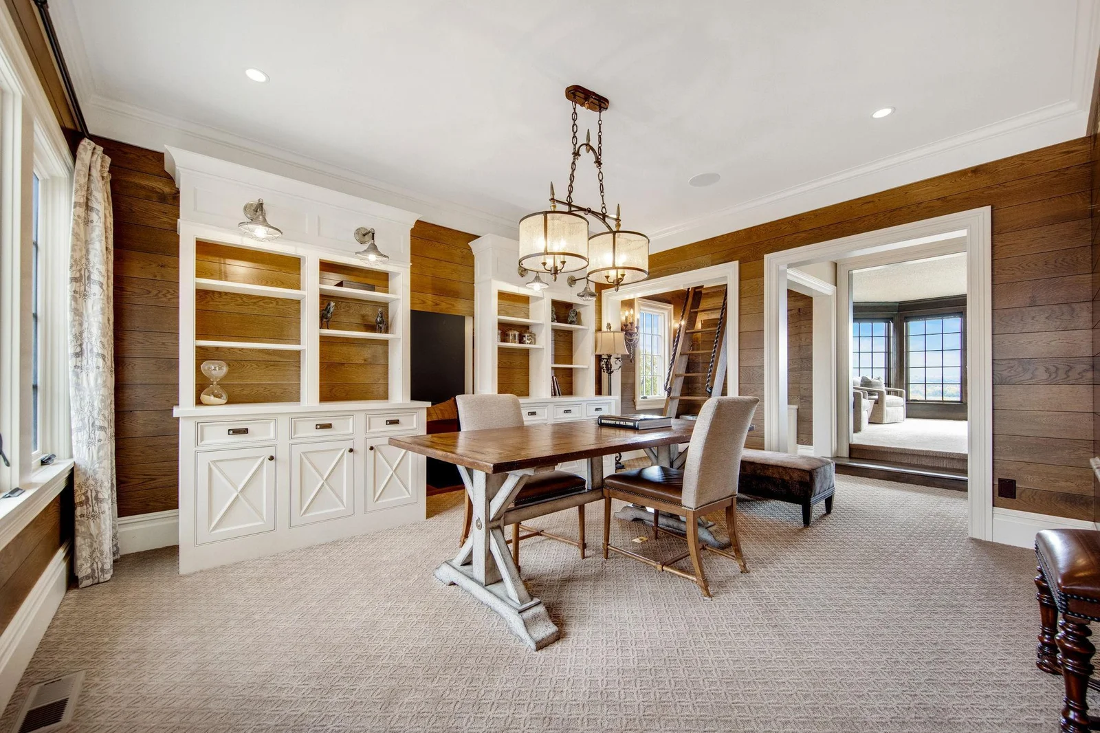 The upper-level office space is a versatile gem, featuring two interconnected rooms that flow seamlessly into one another.