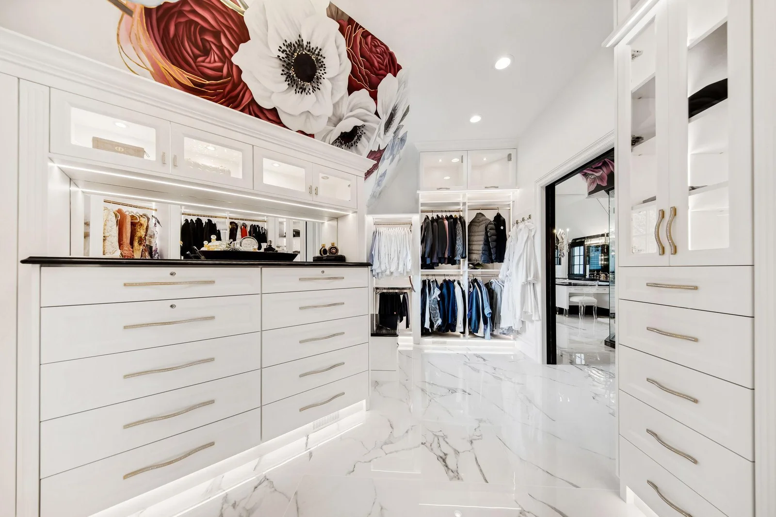 Custom cabinetry and elegant shelving maintain the cohesive aesthetic, ensuring everything is beautifully displayed yet easily accessible.