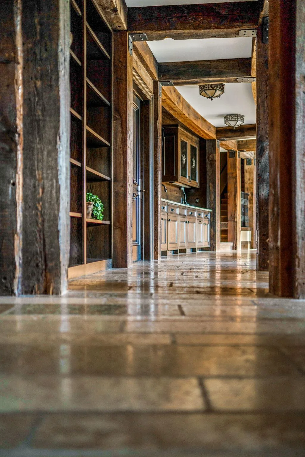 The lower level exudes true rustic charm, featuring exposed beams that add character and warmth to the space. The design embraces natural materials, creating an inviting atmosphere that feels both cozy and sophisticated.