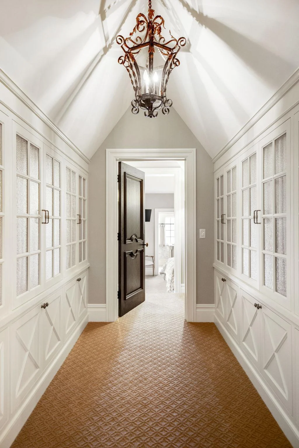 As you move down the hallway, custom built-ins line the walls.