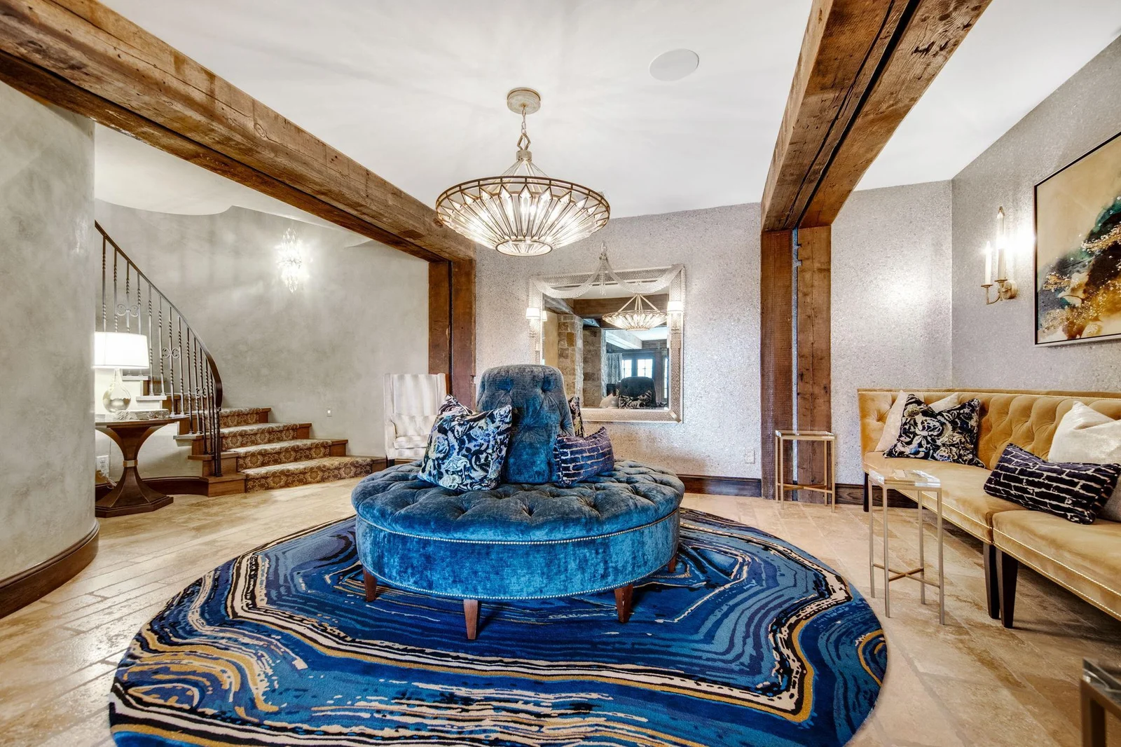 Heading downstairs, you enter a full entertainer's dream that exudes luxury and style. The expansive open layout is perfect for hosting gatherings, featuring a spacious lounge area adorned with plush seating and elegant decor.