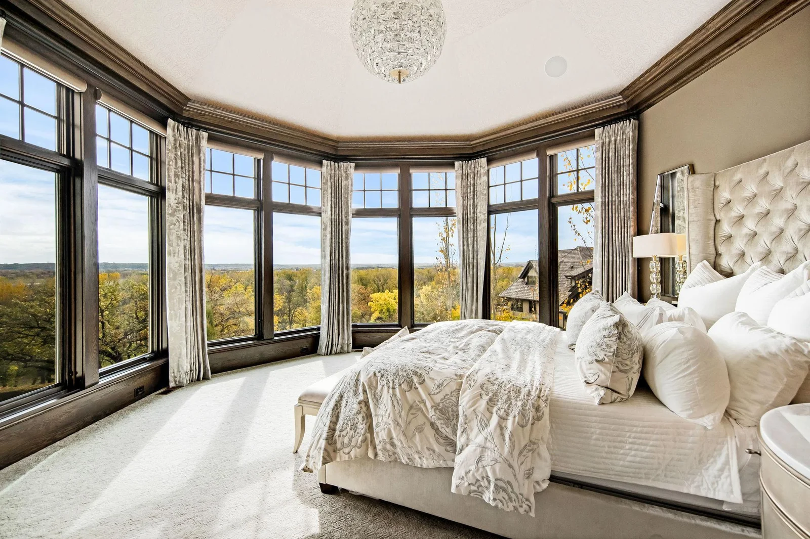 The main floor primary suite is a true sanctuary, offering stunning panoramic views from every angle.