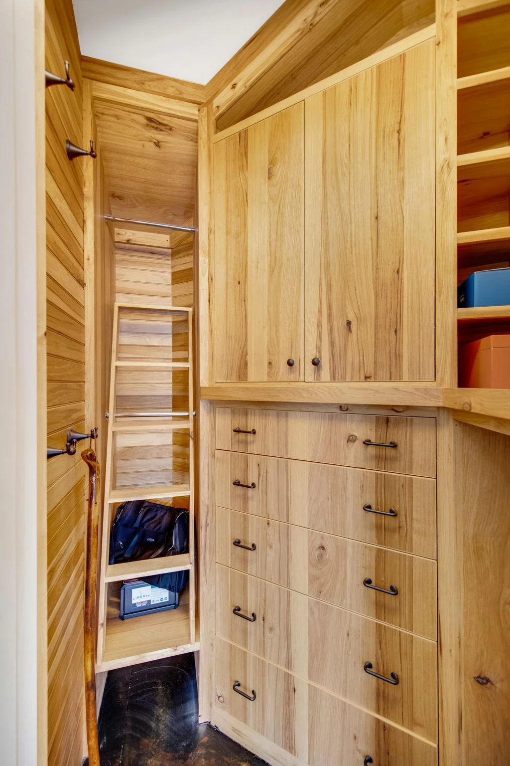 In the garage, a locked cedar closet room offers a secure and strategic placement within the garage providing a discreet yet practical solution for keeping your belongings safe and protected.