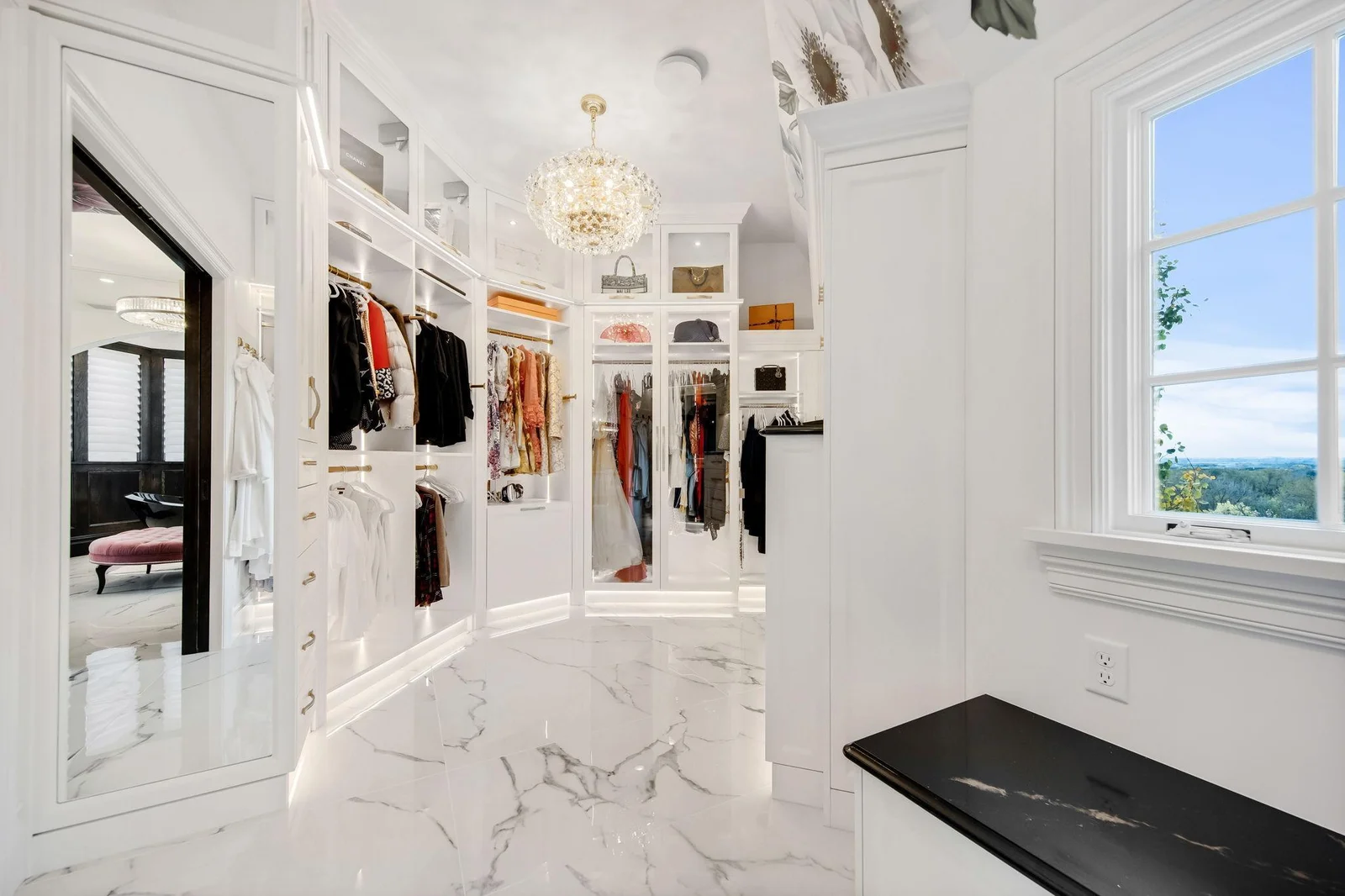 The closet is a true masterpiece, designed to be both functional and visually stunning. Expansive and thoughtfully laid out, it features elegant shelving and display areas that highlight your wardrobe.