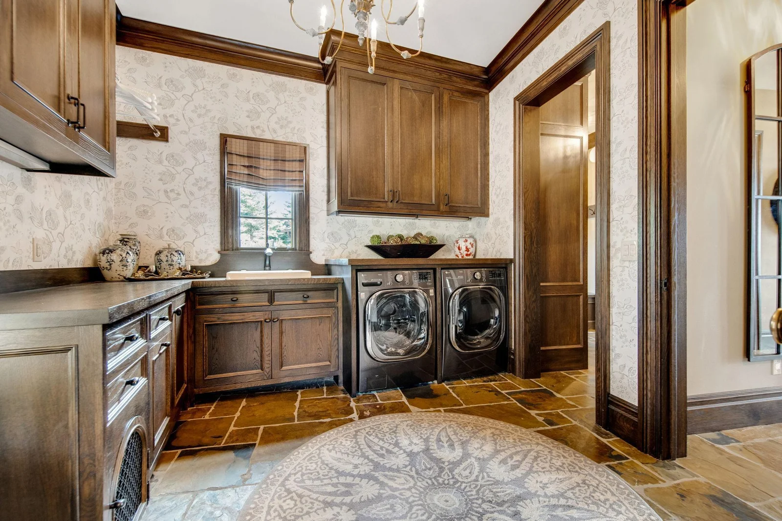 The main floor mudroom is designed for convenience and organization. Featuring ample storage. A well-equipped laundry area is integrated seamlessly. Adding to the functionality, a charming doggie door leads out to the garage.