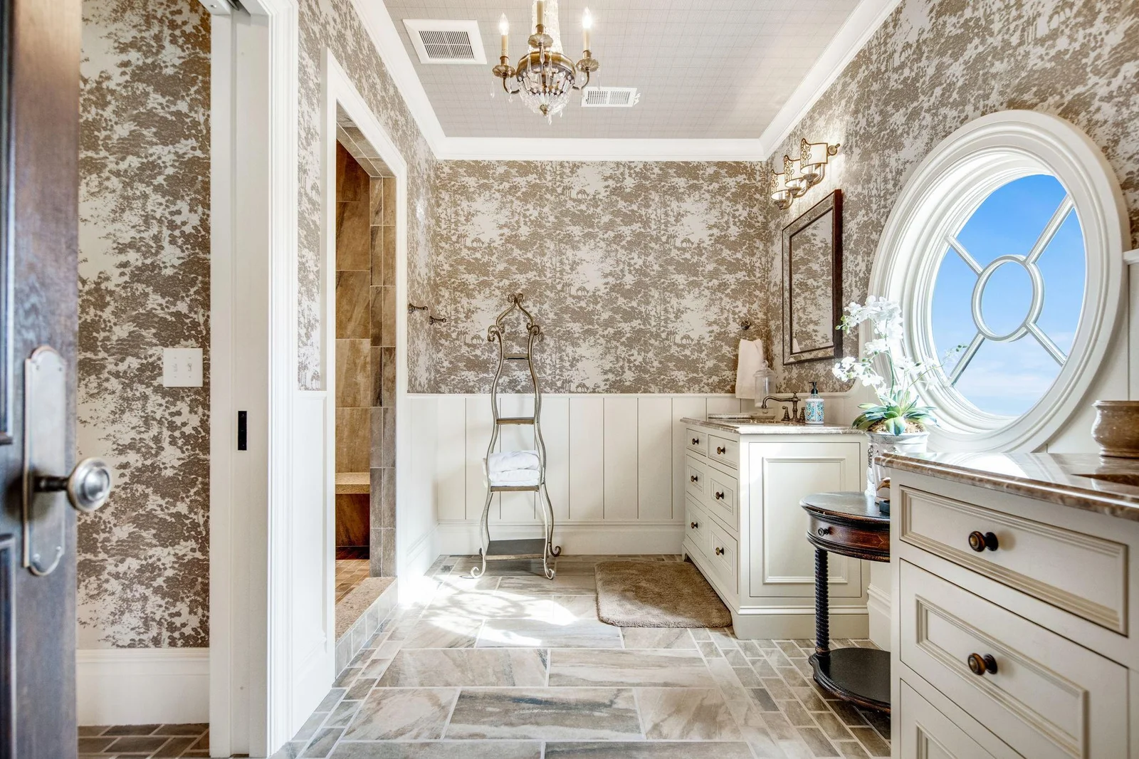 The attached private bathroom is elegantly appointed. It includes a spacious walk-in shower and luxurious finishes, ensuring a spa-like experience.
