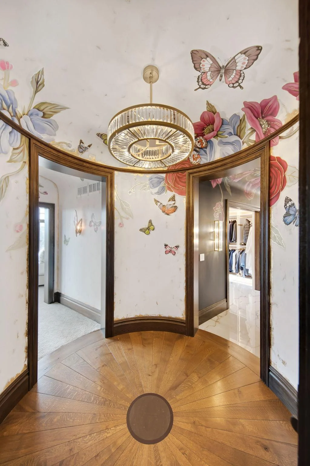 As you enter the rotunda, you're immediately captivated by the stunning custom hand-painted walls. This beautiful space serves as a grand transition to the owner's primary retreat.