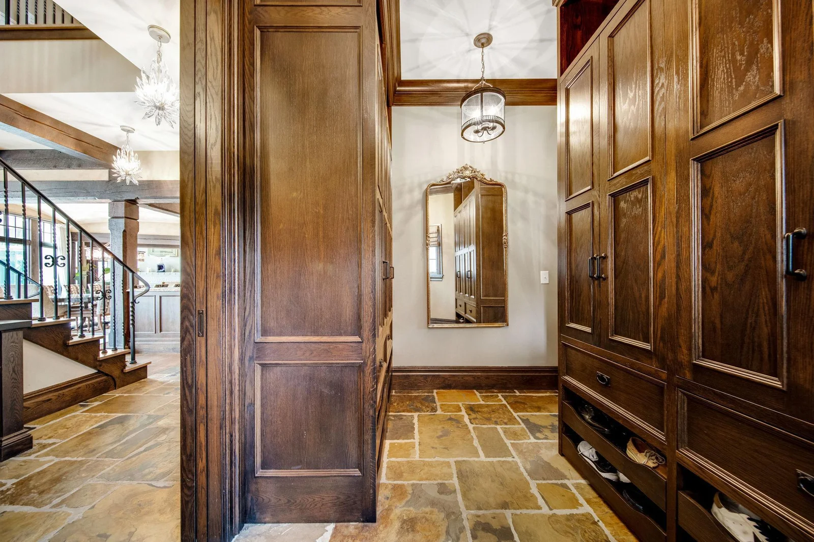 Featuring ample storage with built-in cabinetry and hooks, it provides a dedicated area for coats, bags, and shoes, keeping clutter at bay.