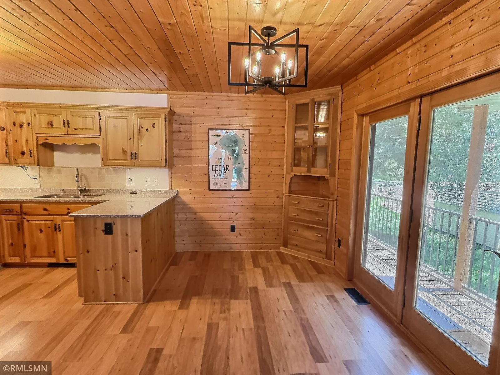 The covered side deck opens to the spacious dining room, what a space to enjoy all your meals and each other.