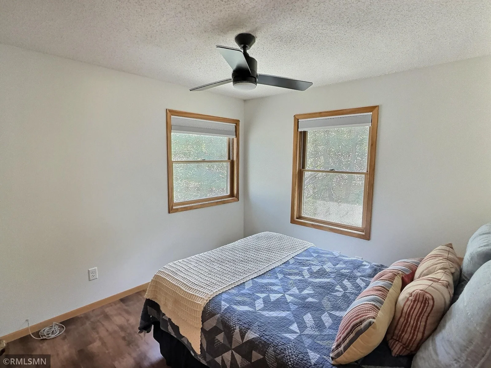 Perfect for weekend guests or kids, the second bedroom located in the upper level is bright with sunlight.
