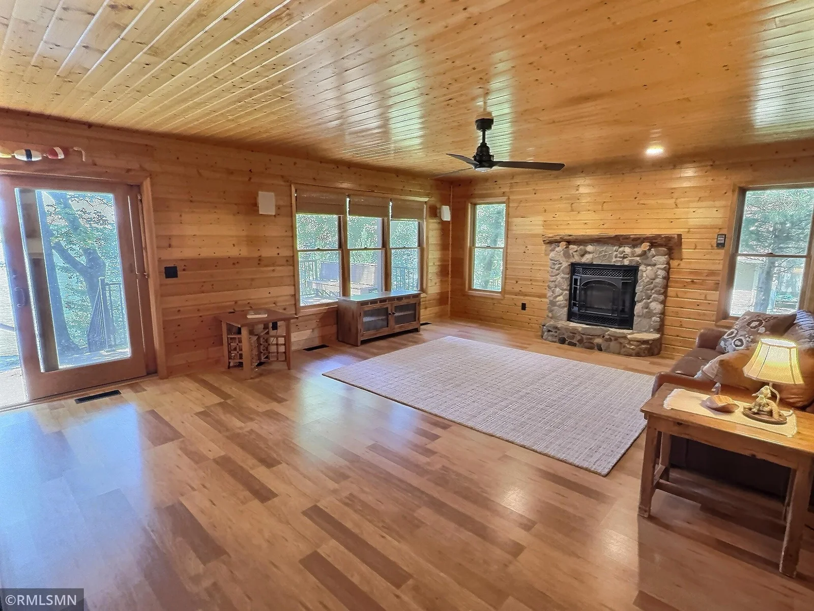 Gather and entertain in the lakeside living room showcasing breathtaking views of the Cedar Lake shoreline.