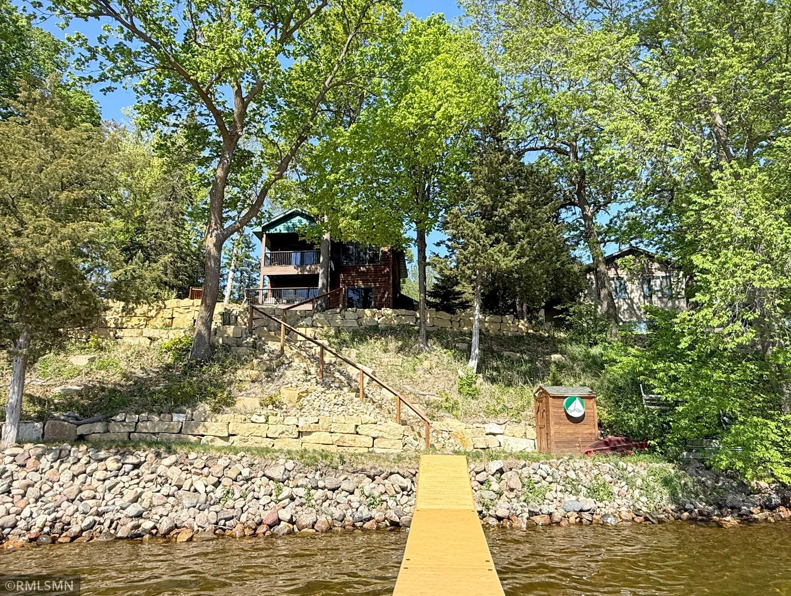 Another view of the gorgeous landscaping and home tucked in the trees - fall in love with the view anytime of the year.