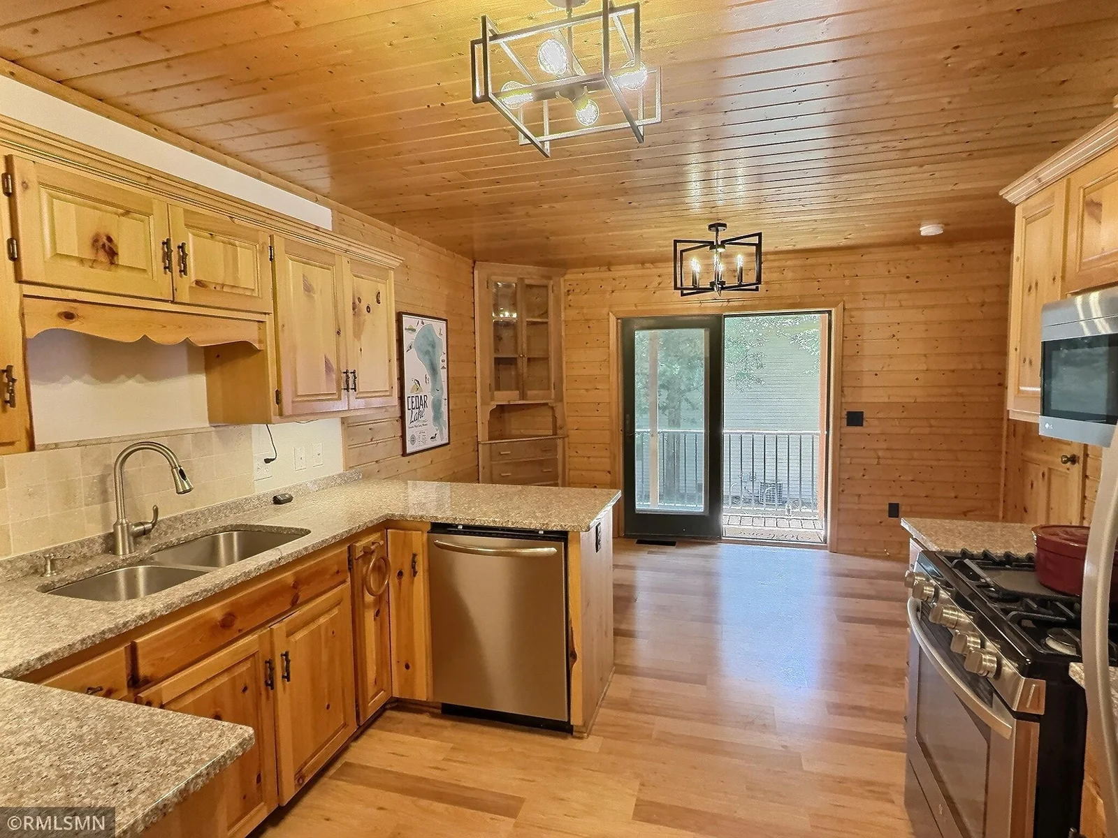 The dining room opens to the main level living room, the door to the left leads to the finished lower level.