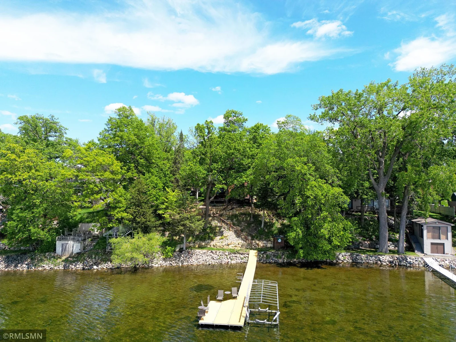 Professional limestone block landscaping spans the entirety of the property offering the perfect backdrop for lake views.