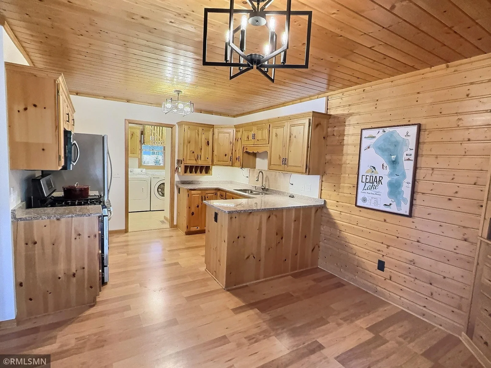 Granite countertops, knotty cedar cabinets and ceiling and newer flooring finish off this main level kitchen.