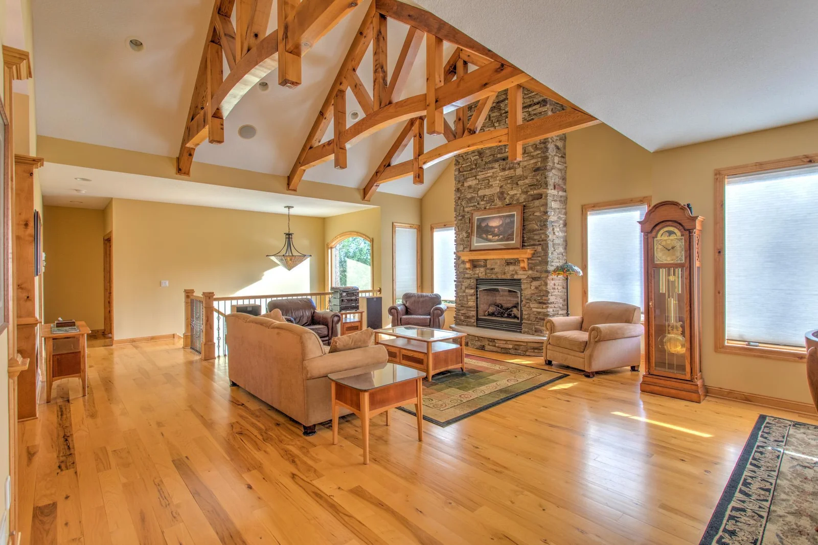 Sun-drenched South facing living room with stacked stone hearth and gas burning fireplace