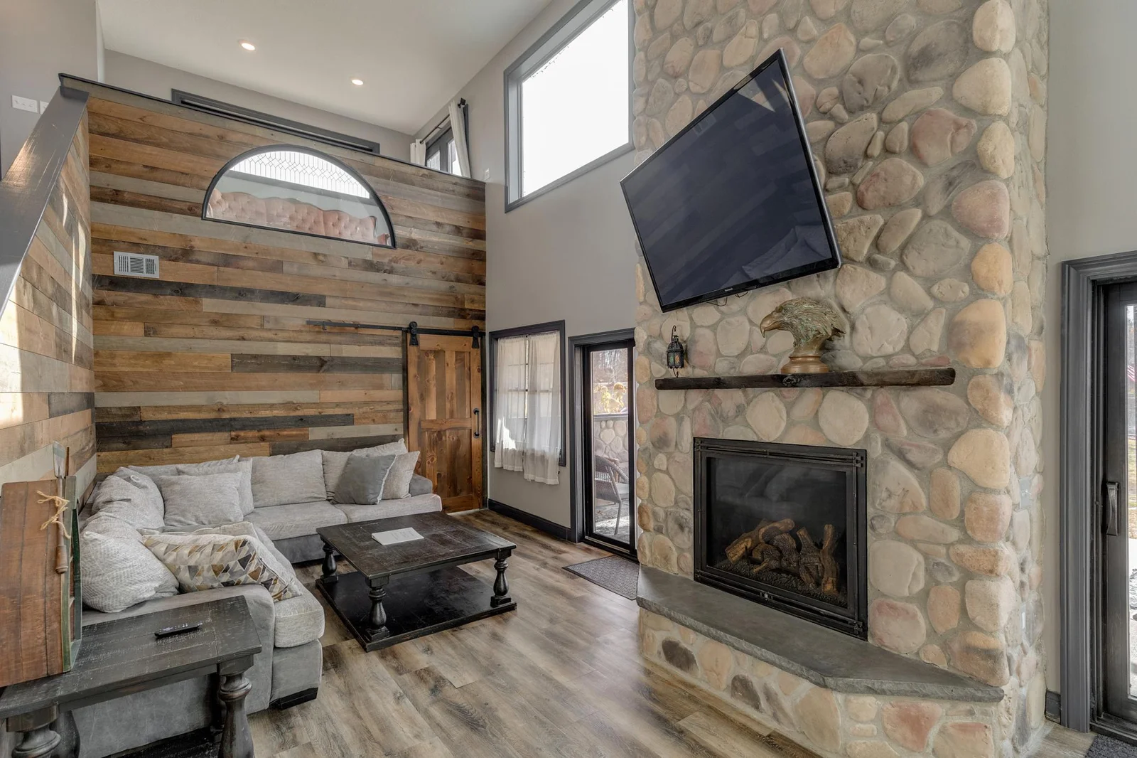 Floor to ceiling stone gas fireplace.